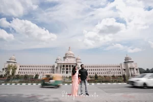 A couple posing in front of a building in hyderabad.