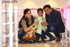 A man and woman posing for a photo with a young boy.