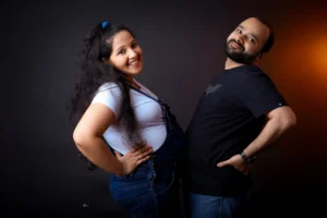 A man and pregnant woman posing for a photo.
