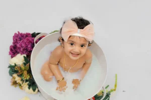 A baby in a bucket of milk.