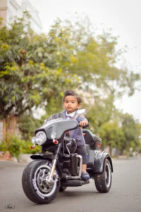 A child champ is riding a motorcycle on a street.